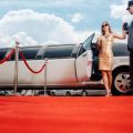 Driver Helping Vip Woman Or Star Out Of Limo On Red Carpet To A Reception